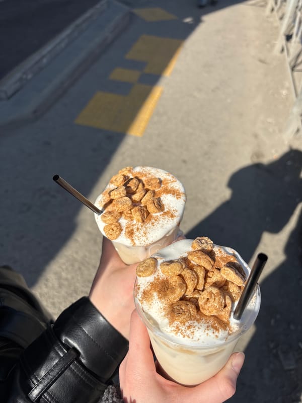 Two people share cold drinks on sunny Perm street