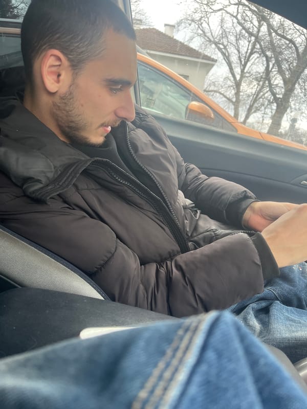 Man using phone in car during early morning in Varna