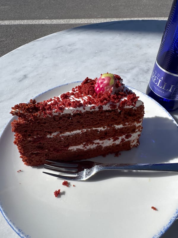 Red velvet cake enjoyed at outdoor table in Andratx