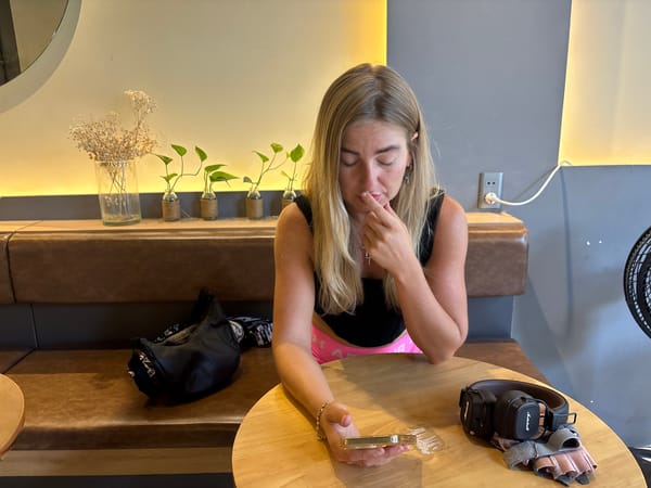 Woman with phone observed at traditional café in Đà Nẵng
