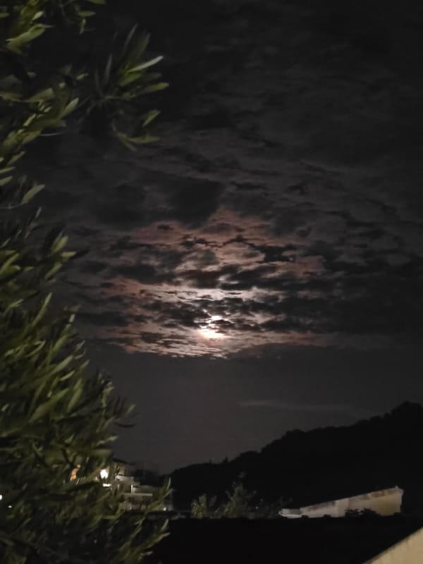 Moonlight breaking through clouds over Petrovac at night