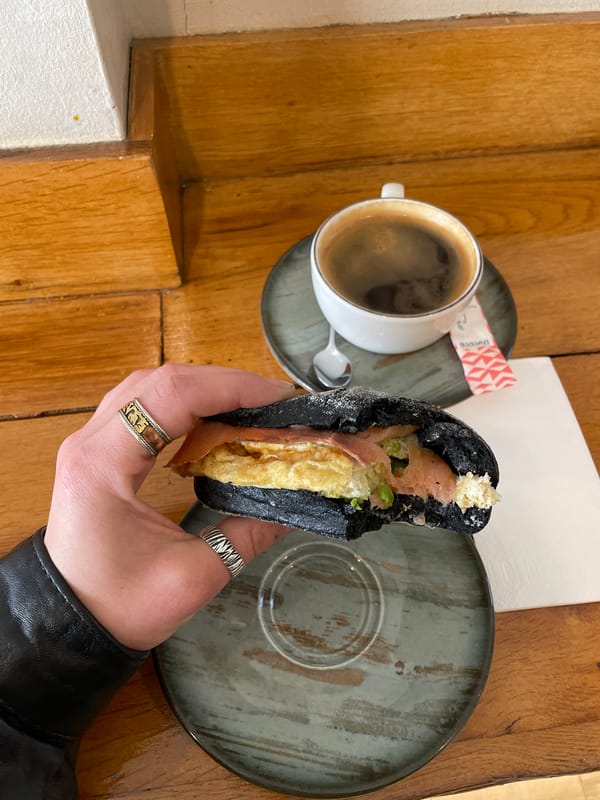 Morning cafe dining captured in Tbilisi featuring charcoal sandwich