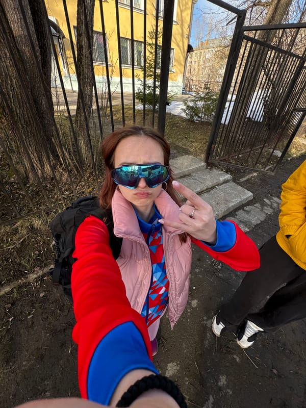 Two people pose for photos on Berezniki street