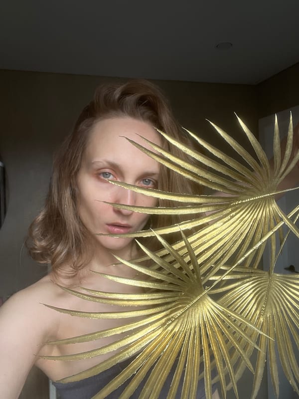 Woman poses behind gilded palm fronds in Podshivalovo portrait