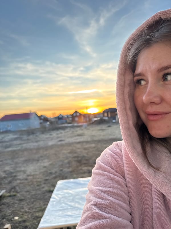 Woman captures golden hour selfies in rural Russian village