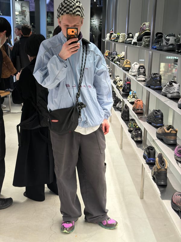 Person takes mirror selfie in Shibuya retail store