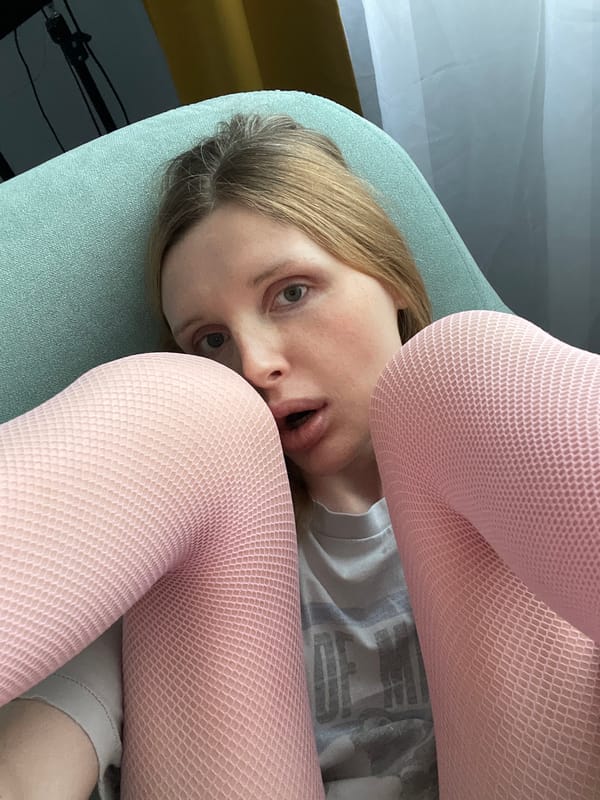 Pink fishnet tights and mirror selfies in a Yablonovskiy apartment