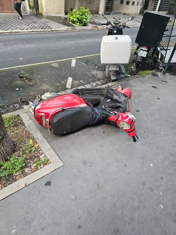 Scooter parked on sidewalk in Pantin, France