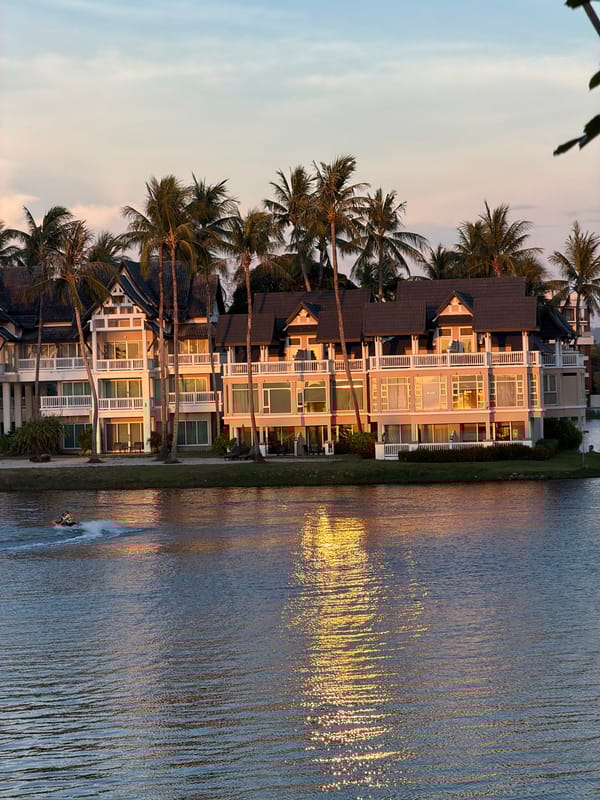 Woman enjoys poolside cocktail at Thai resort