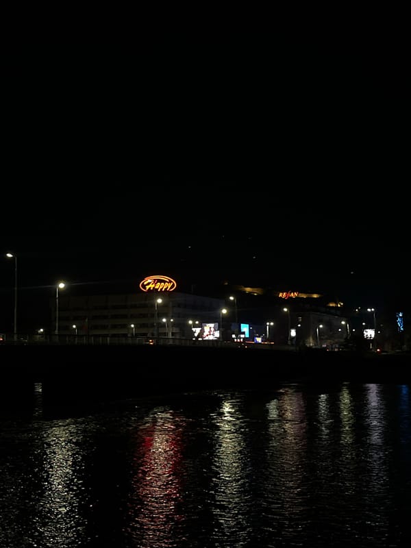 Plovdiv restaurant lights reflect in water at nighttime