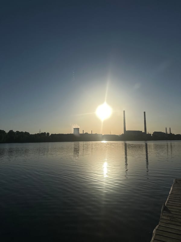 Man contemplates waterfront near industrial area in Kazan