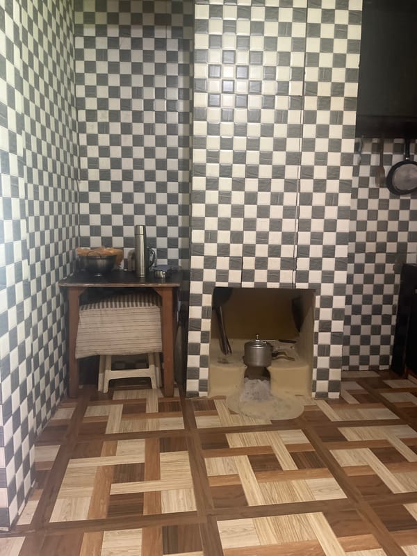 Inside a tiled kitchen and its surrounding space