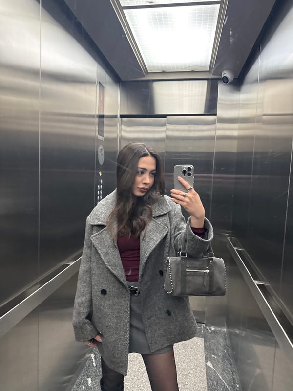 Woman takes elevator selfie, kitchen view captured in Yerevan