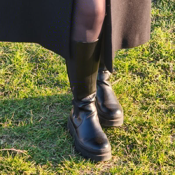 Person uses smartphone in Hrodna park on sunny afternoon