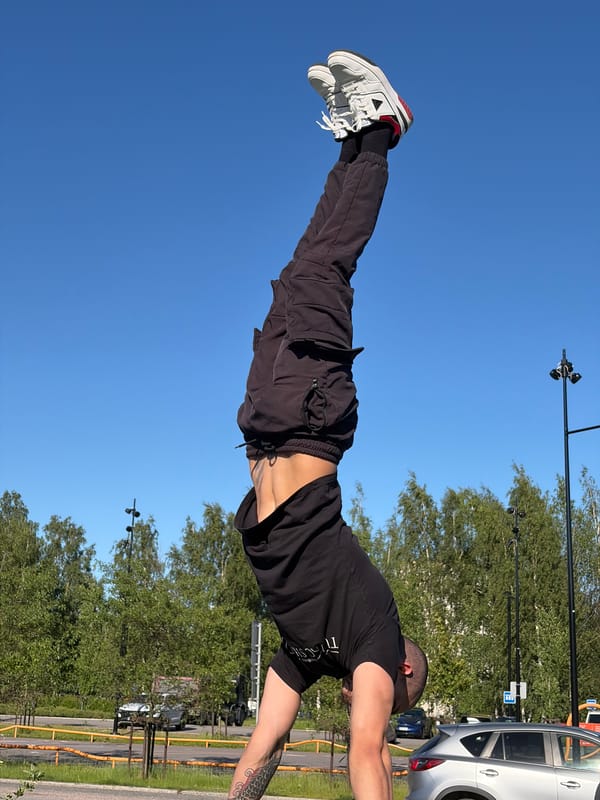 Individual practices handstands at Vantaa sports parks during sunny afternoon
