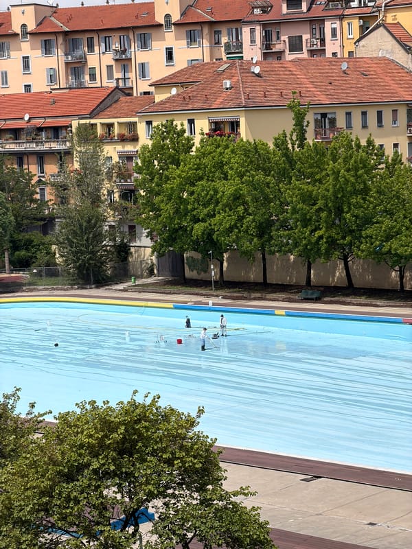 Pool maintenance workers clean swimming facility in Milan