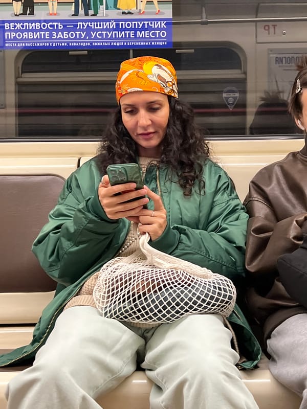 Woman uses smartphone on train in Shushary, Russia