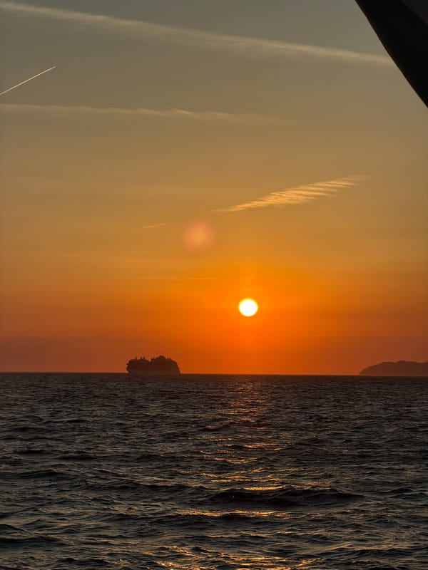 Sailboat catches sunset light off Anacapri coast
