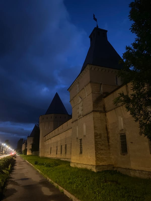 Novodevichye Monastery glows under a deep blue evening sky.
