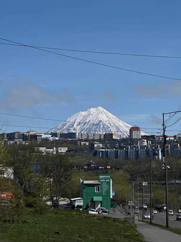 Snow-covered volcanic peak overlooks Petropavlovsk-Kamchatsky cityscape
