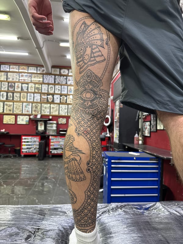 Person displays intricate leg tattoos featuring Orthodox church in Moscow