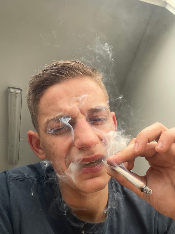 Man documents smoking session in industrial building with safety gear