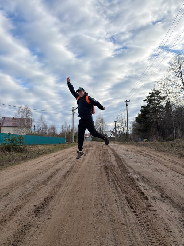 Family walks rural dirt road in Chaikovsky, Russia