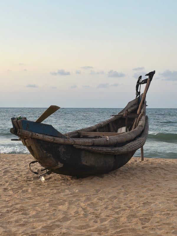Beach scene captures fishing boat and child at play