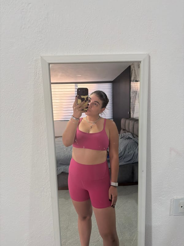 Woman takes mirror selfies in pink workout attire, Puebla