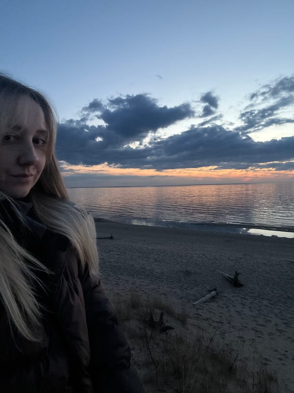 Woman takes beach selfie at sunset in Riga