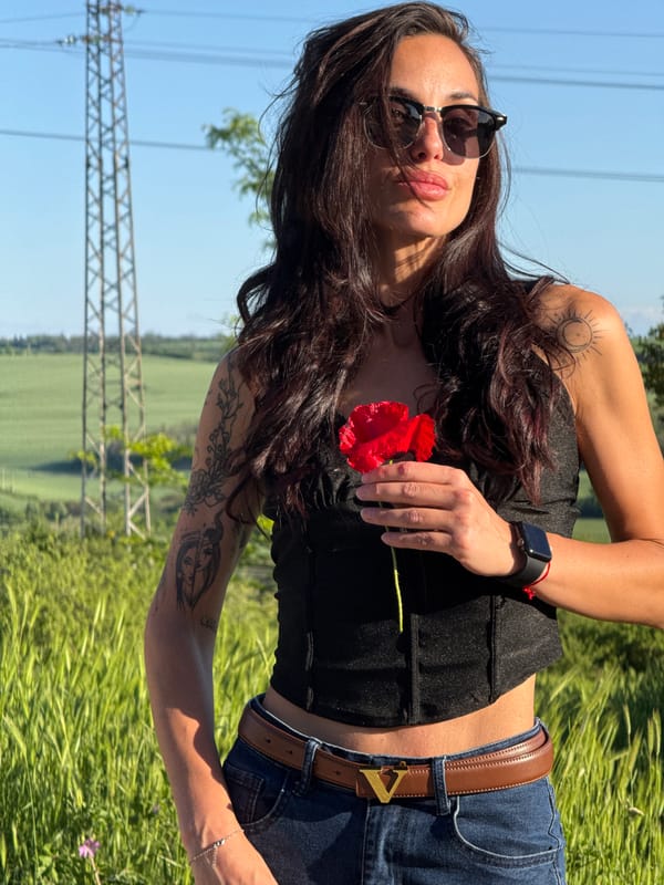 Woman holds red poppy in Pleven park