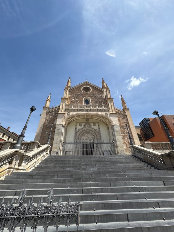 Madrid church and bronze statue observed in city park