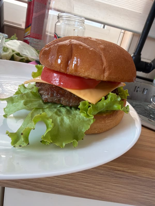 Man poses with burgers in Montenegro restaurant