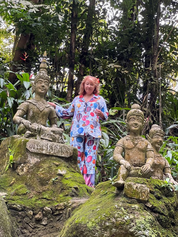 Tourist explores weathered stone musician statues in Ko Samui jungle