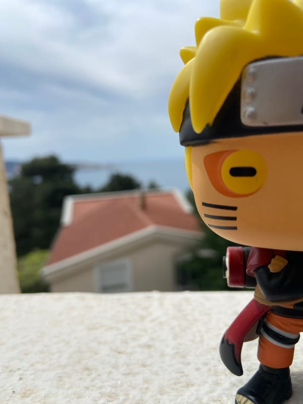 Anime figurine photographed on Montenegro balcony overlooking Adriatic Sea