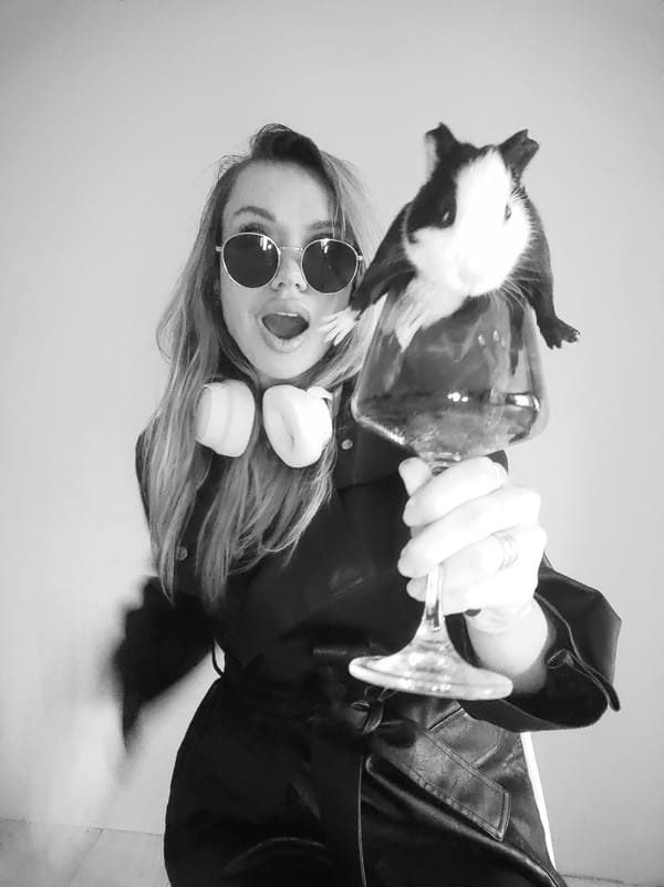 Woman poses with guinea pig on wine glass in Russia