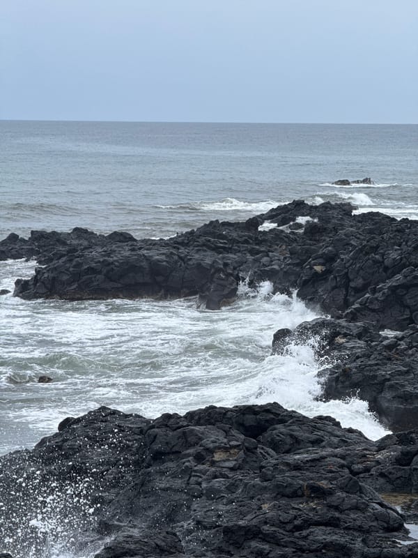 Lý Sơn's volcanic coastline on a rough, overcast morning