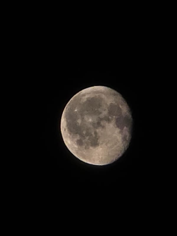 Full moon photographed over Worms, craters and light streaks visible
