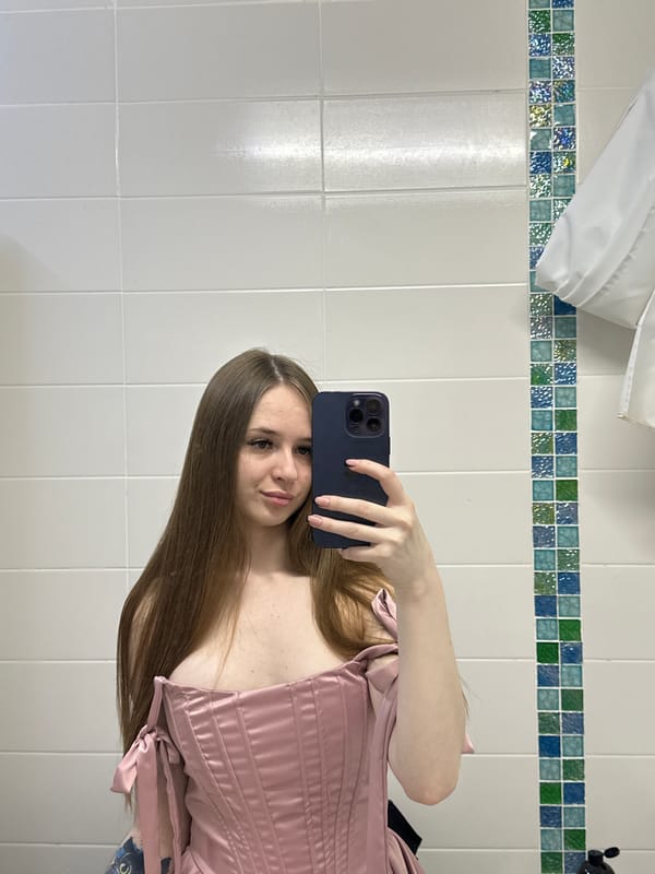 Woman in pink corset photographed in multiple indoor locations