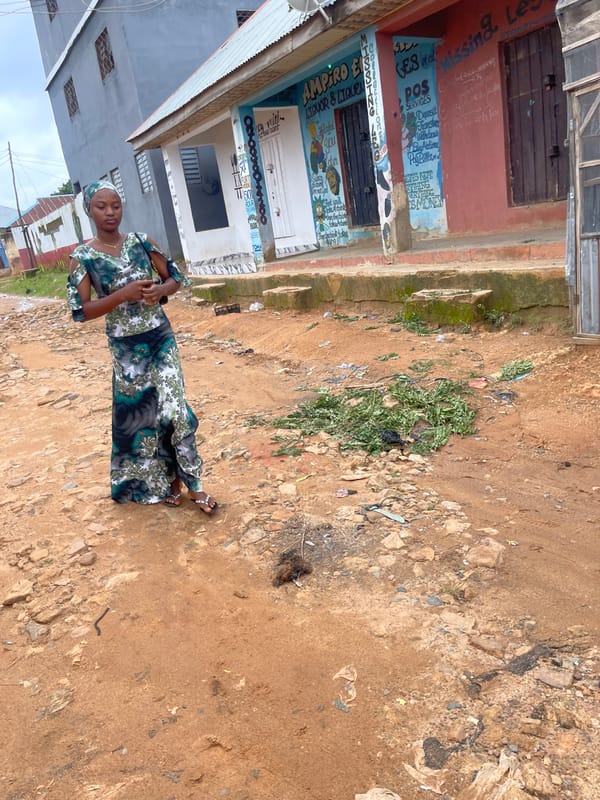 Street-level life on a dusty Jos morning, June 2026