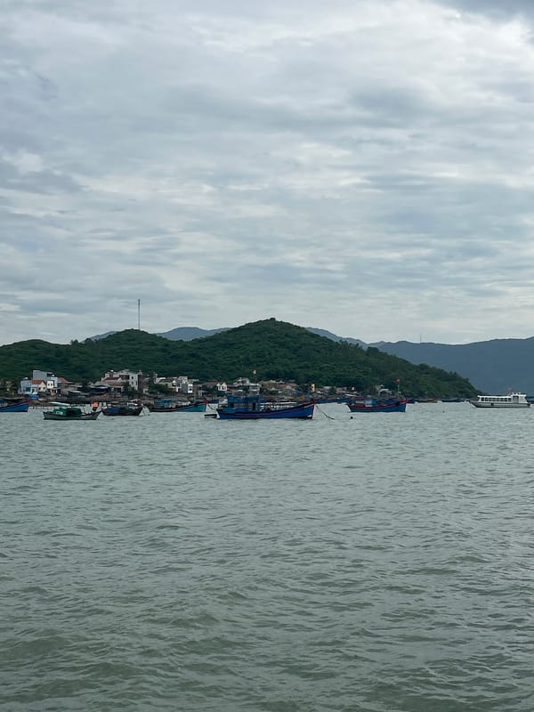 Fishing fleet anchored off the cloudy coast of Ninh Ích