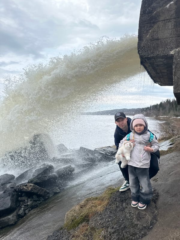 Family visits waterfall dam in Noviy, Russia