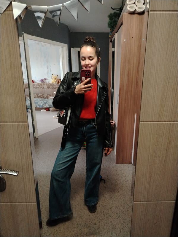 Woman takes mirror selfie in residential space in Noviy