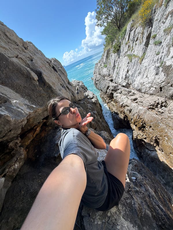 Woman documents coastal exploration at Montenegro cliffs during morning visit