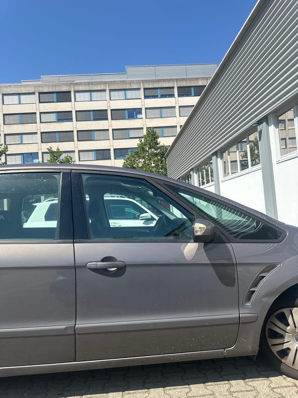 Parked outside a REWE, chilling in a Smart car
