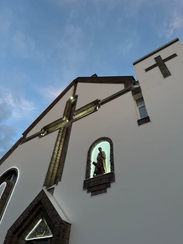 Church facades and carved stone sculptures in Smarhon at dusk