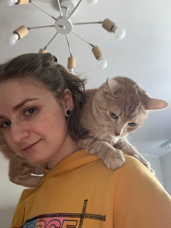 Woman and orange cat share quiet moment in Novosibirsk