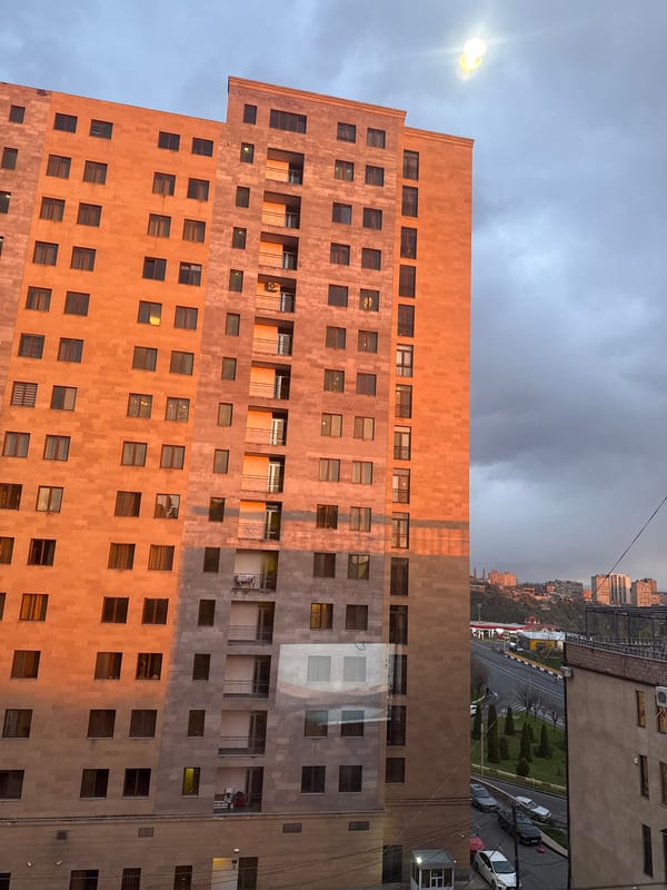 Stone facade building with orange-gray blocks documented in Yerevan