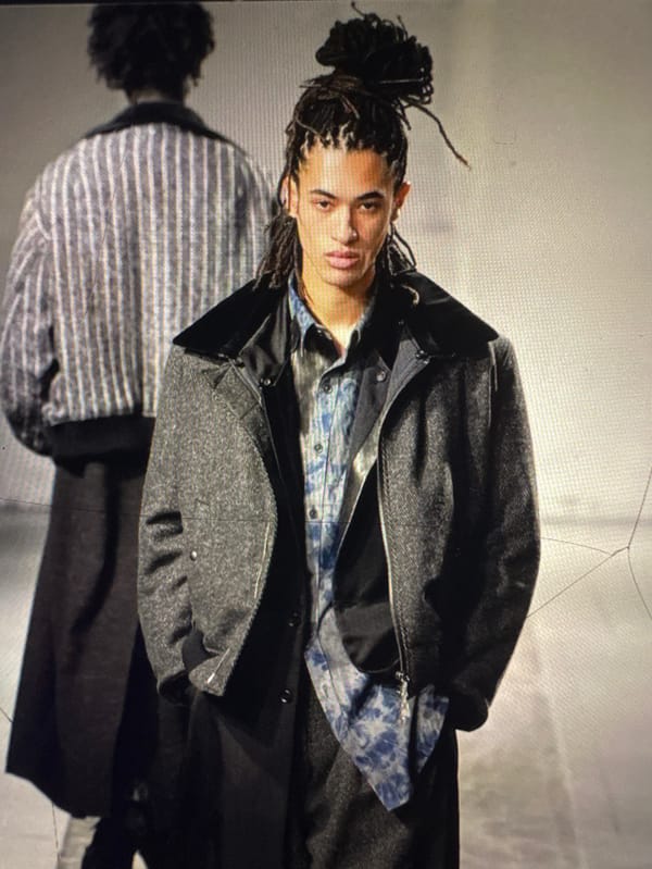 Person with dreadlocks photographed in various poses in Les Ulis