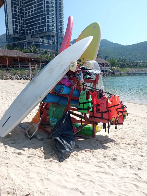Nha Trang beach morning: kayaks, calm bay, and coastal construction